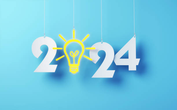 istock Paper Cut 2024 New Year letters with Yellow Light Bulb Hanging on String and Blue soft background 1847655932