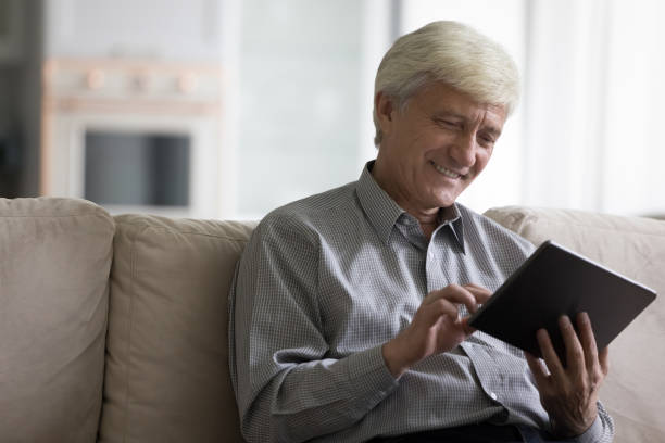 istock Cheerful retired pensioner man using online app on digital tablet 1847656213