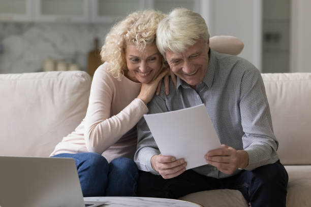 istock Happy joyful elder retired couple sitting close on couch 1847656255