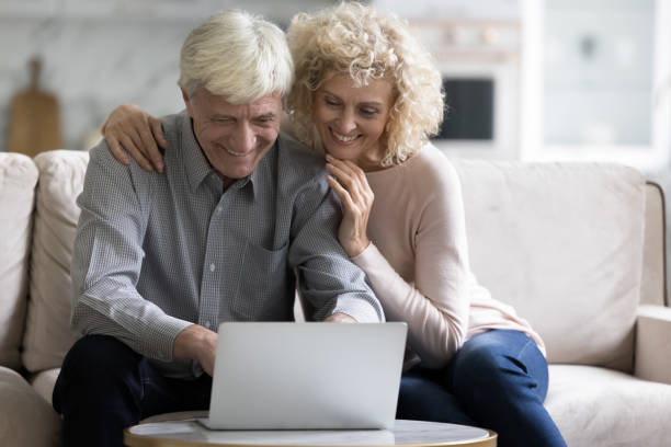 istock Cheerful senior old couple using online app on laptop computer 1847656278
