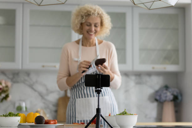 istock Happy senior cook blogger lady shooting workshop on smartphone 1847656304