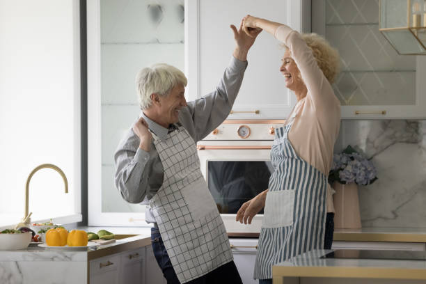istock Happy cheerful active elder couple in aprons training social dance 1847656313