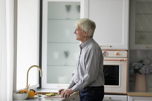 istock Thoughtful happy elder retired man enjoying cooking at home 1847656323