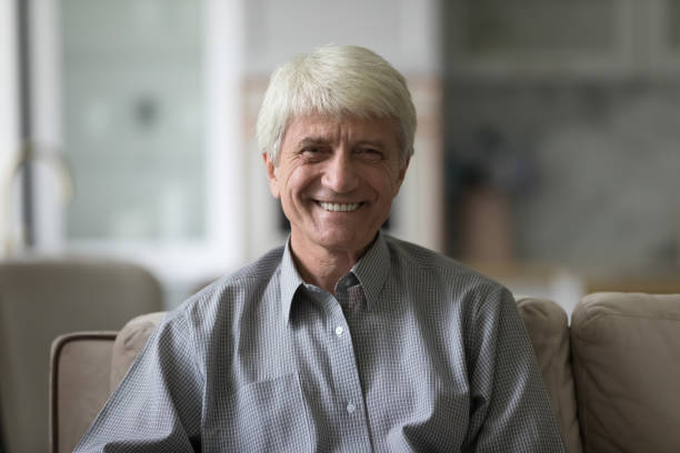 istock Happy handsome grey haired senior retired man looking at camera 1847656361
