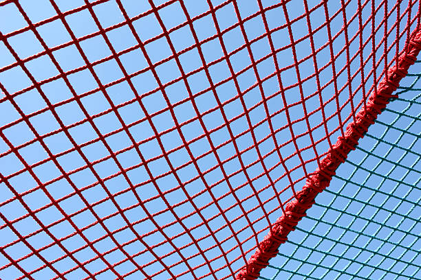 safety red nets against clear blue sky close up of safety blue nets against clear blue sky safety net stock pictures, royalty-free photos & images