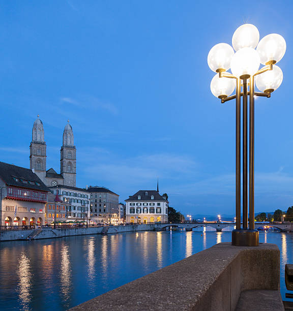 City of Zurich, Switzerland, summertime evening, view along the Limmat river with Great Minster towers at the background.