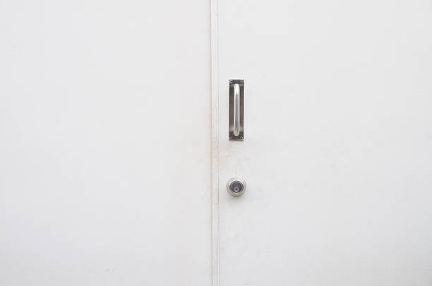 istock White door close with steel handle and key. 184767876