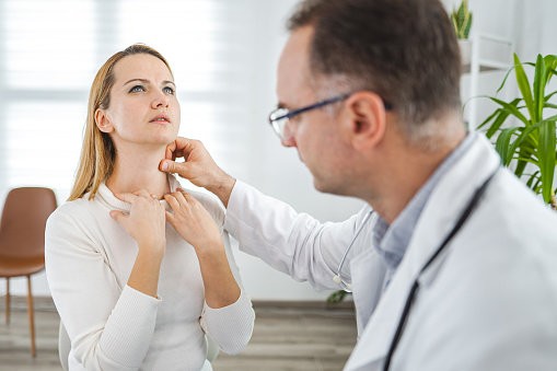 Male doctor examining female patient at the doctors office