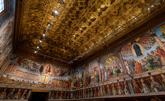 Toledo, Spain - March 18, 2023: Chapter room of the Cathedral of Saint Mary in Toledo, Spain, filled with paintings and art to celebrate the extraordinary meetings of its Chapter. UNESCO World Heritage Site