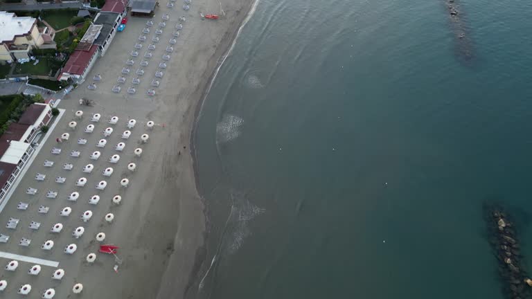 Aerial view of a beach with many beach umbrellas