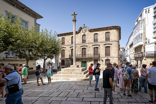 Raised cross in front of Collegiate Church of Santa María del Campo in medieval quarter of La Coruna, Galicia, Spain on 22 August 2023