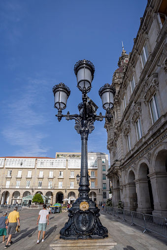 Ornate Lamp Post in front of the historic Town Hall of La Coruna in Maria Pita Sqaure in A Coruna, Galicia, Spain on 22 August 2023