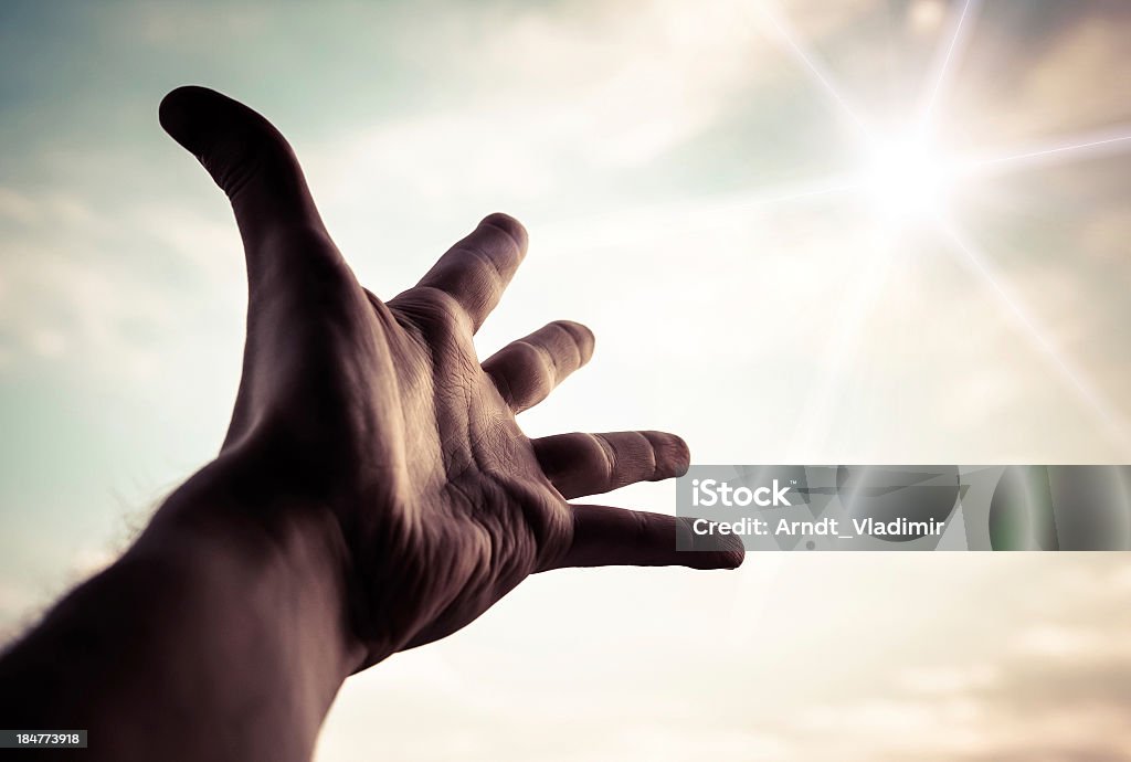 Hand reaching to towards sky. Hand of a man reaching to towards sky. Color toned image. Growth Stock Photo