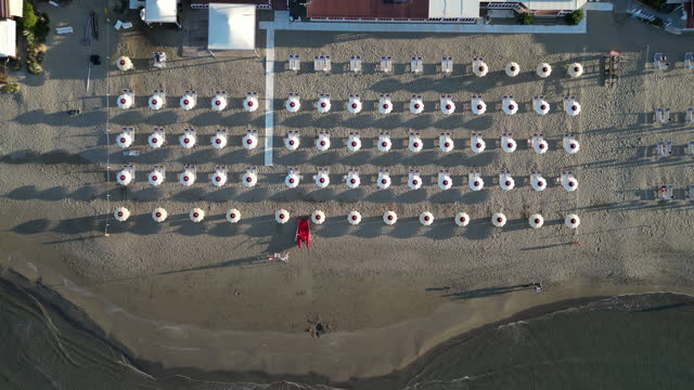 Aerial view of a beach with many beach umbrellas