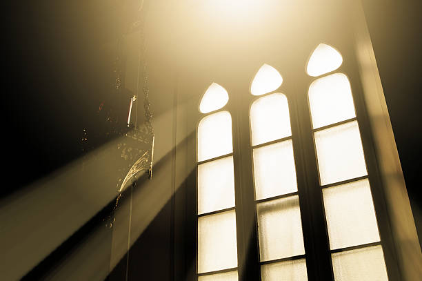istock Rays of light through glass in a window church 184779774