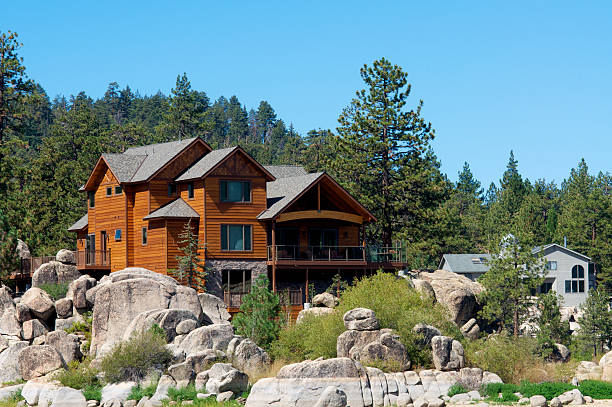 Mountain wooden cabin next to a lake A log cabin on a lake in California.  clear sky usa tree day stock pictures, royalty-free photos & images