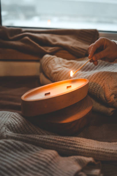 istock A match lights a candle in wood, stylish interior 1847820049