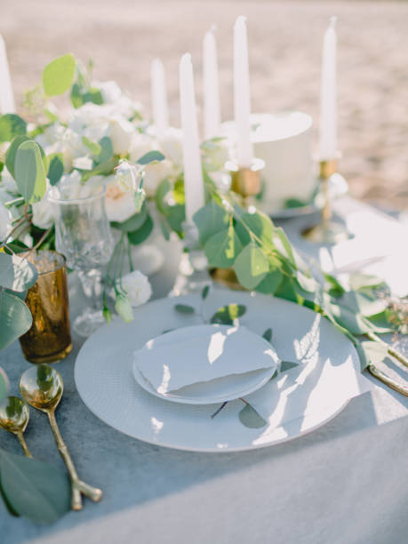 istock Elegant table setting with a paper card decorated with eucalyptus branches close up. Romantic table with paper invitation card. Wedding Mockup. 1847820692