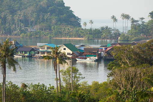 A group of houses in a small bay, surrounded by rainforest, south of Koh Chang Island, in the Gulf of Thailand