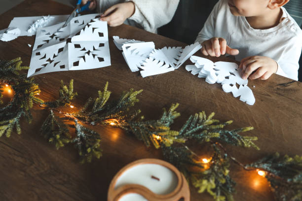 istock Children cut out snowflakes, Christmas activity 1847822960
