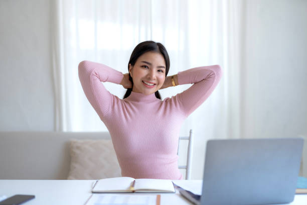 istock Happy young Asian woman relaxing using laptop computer at home. 1847826782