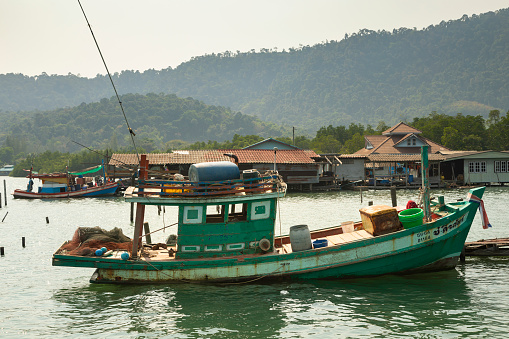 Thailand - Jan 15, 2020: An old wooden fishing boat moored on the island of Koh Chang in the Gulf of Thailand