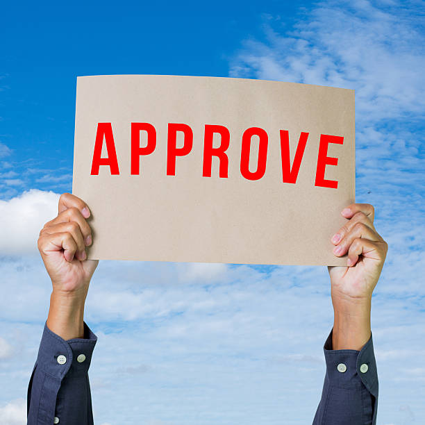 istock Hands holding brown paper with approve 184782899