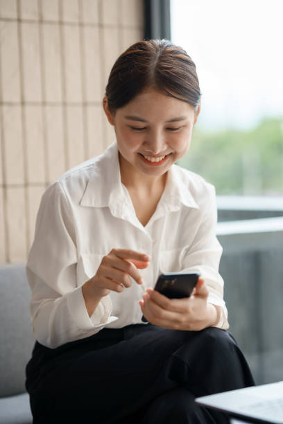 istock Attractive young Asian woman using mobile phone in the cafe. 1847829041
