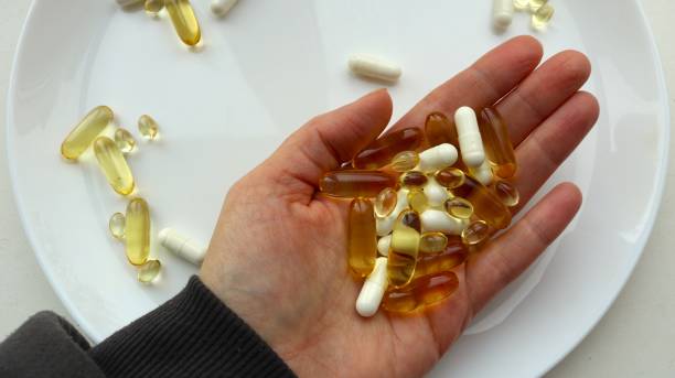 istock vitamin capsules on a woman's palm close-up 1847833898