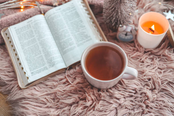 istock Open Bible in cozy pink winter home morning atmosphere 1847837101