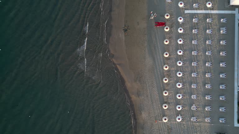 Aerial view of a beach with many beach umbrellas