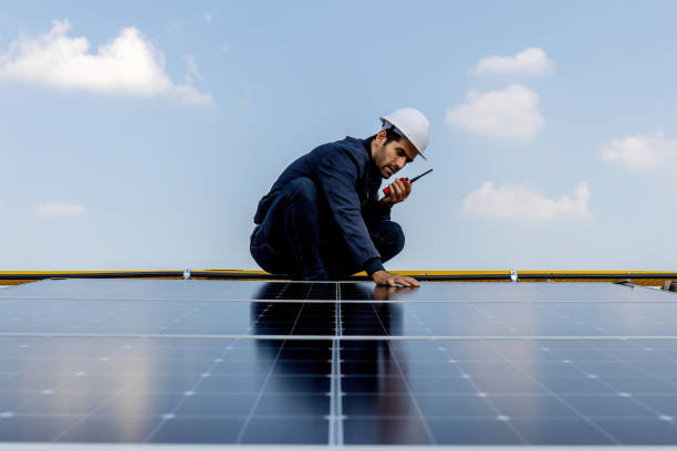 istock Engineer working setup Solar panel at the roof top. Engineer or worker work on solar panels or solar cells on the roof of business building 1847841414