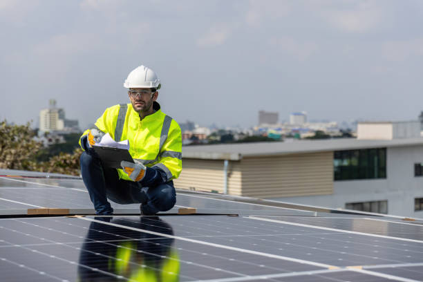 engineer working setup solar panel at the roof top. engineer or worker work on solar panels or solar cells on the roof of business building - 24417 imagens e fotografias de stock