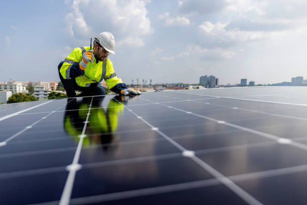 istock Engineer working setup Solar panel at the roof top. Engineer or worker work on solar panels or solar cells on the roof of business building 1847841451