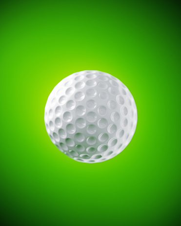White golf ball on green background. Vertical composition.