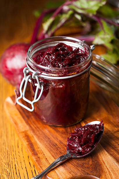 Red beetroot chutney in a jar with a spoon Beetroot and balsamic chuthey chutney stock pictures, royalty-free photos & images