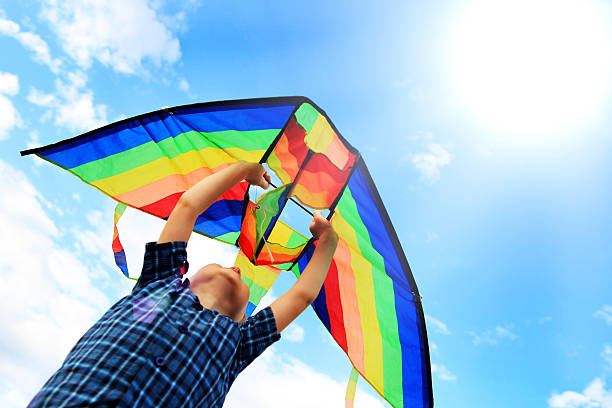 llittle boy flies a kite in the sky - flying kite bildbanksfoton och bilder