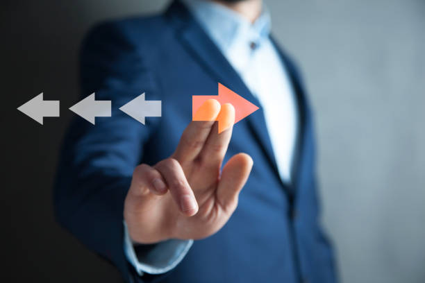 istock Point to orange arrow and different direction facing opposite 1847863030
