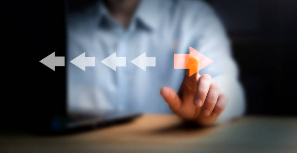 istock Point to orange arrow and different direction facing opposite 1847863188