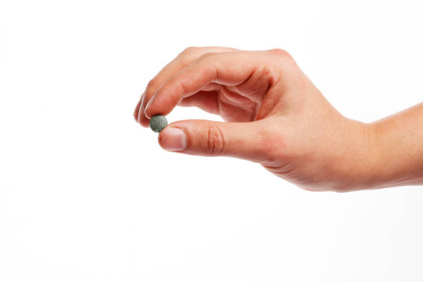 istock spirulina pill in hand isolated on white background 1847865722