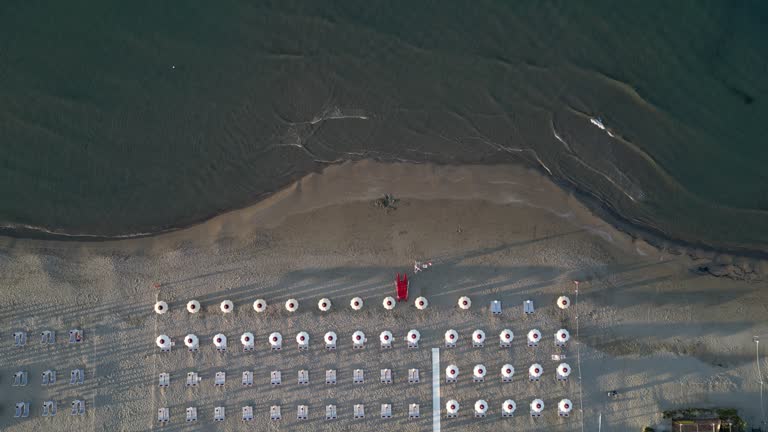 Aerial view of a beach with many beach umbrellas