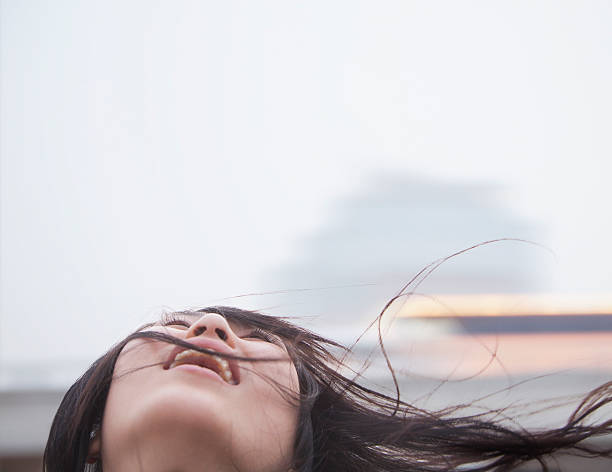 istock Young woman with hair blowing 184787397