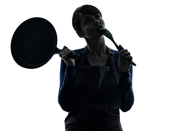 woman cooking holding frying pan thinking silhouette