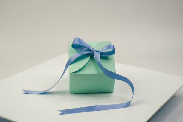 istock a blue and green present on top of a white plate 1847878338