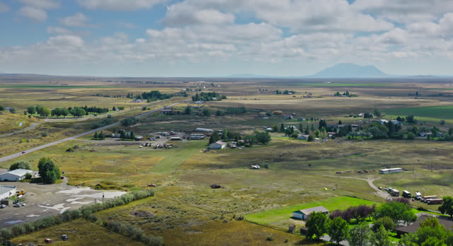 Fluffy White Clouds Over Farmland in Butte County, Idaho - Aerial