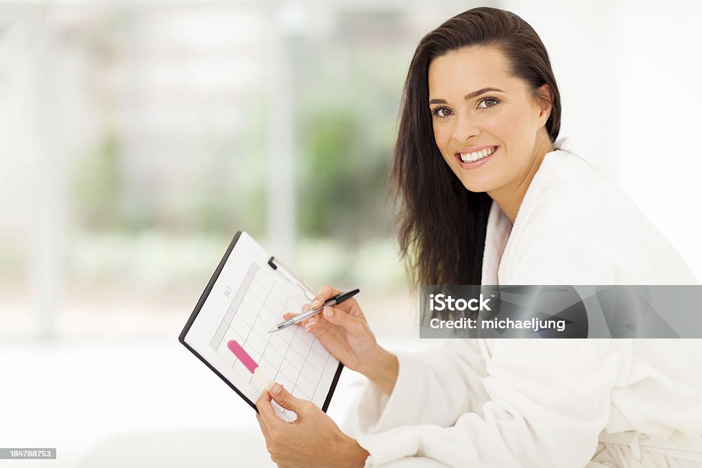 elegant young woman planning pregnancy elegant young woman planning her pregnancy in bedroom at home Adult Stock Photo