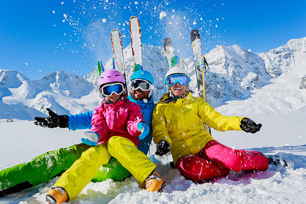 istock A family ski holiday pose with blue sky and snow 184790001