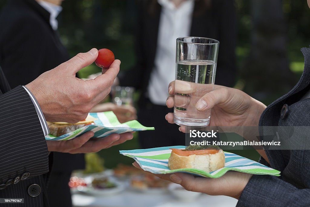 Discussing business people with snacks Business people with snacks discussing during lunch Adult Stock Photo