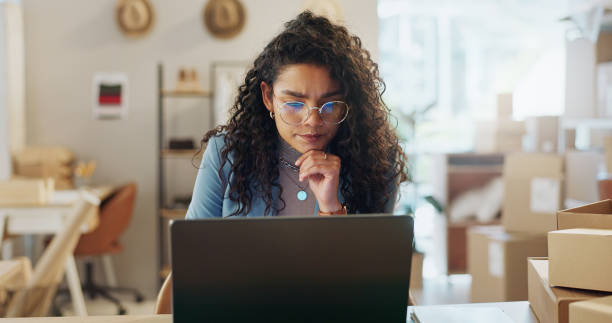 istock Boxes, thinking and woman with a laptop, ecommerce and connection with website information, email or planning. Person, entrepreneur and employee with pc, brainstorming and business owner with startup 1847922338