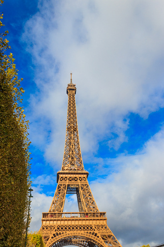 Paris, France - September 30, 2021: Pedestrians go over the Pont d´Lena bridge in Paris. In the background the Eiffel Tower.